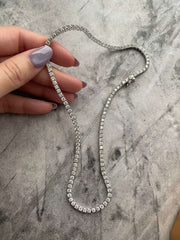 A timeless sparkle that never goes unnoticed.
This tennis necklace is crafted in 925 sterling silver with 18k gold plating, featuring 3mm round-cut zirconia stones that radiate brilliance from every angle.
Designed with a secure figure-8 clasp, it combines sophistication and everyday wearability in a flawless finish.
Length: 16”
Thickness: 3mm
Shine that elevates every look — from casual chic to full glam.